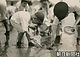 １９２２年５月、学習院初等科のお学友と、千葉県の稲毛海岸で潮干狩りを楽しむ澄宮さま。体操着に紺の足袋をはき、熊手と丸網を手にアサリを掘られている
