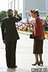 名瀬市（現・奄美市）の奄美群島日本復帰５０周年記念式典会場で、日の丸を振って迎えた人たちに応えられる天皇、皇后両陛下。皇后さまのお帽子には赤いハイビスカスが添えられている