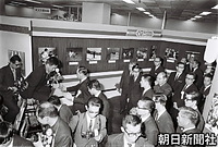 １２月、東京写真記者協会（東京写協）主催の報道写真展を訪れ、美智子さまや浩宮さま、礼宮さまの写真の前でにっこりする皇太子さま。右側後は戸田康英東宮侍従長
