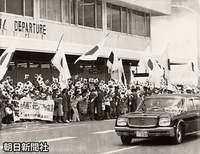 那覇空港から糸満市の南部戦跡に向かう皇太子旗を立てたお車と歓迎する人たち