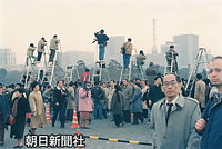 １センチでも高いアングルから皇居前広場の様子を撮影しようとするカメラマンたち